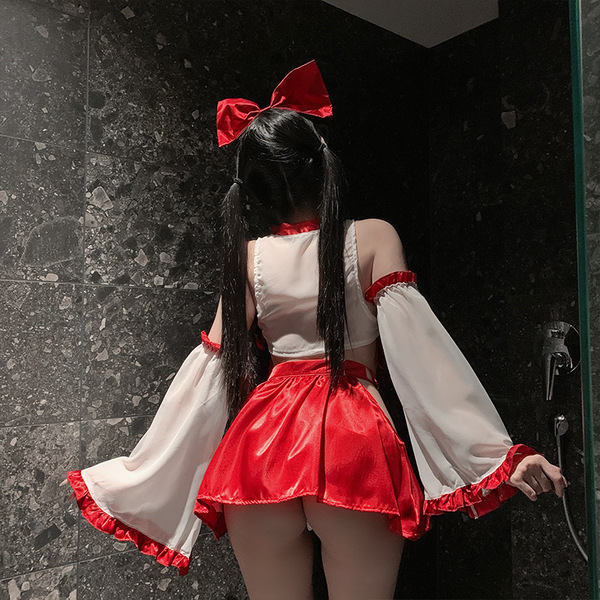 A person wears a white moonlight japanese-style lingerie set featuring red sensual sleep dress with bow and tassel accents, s...