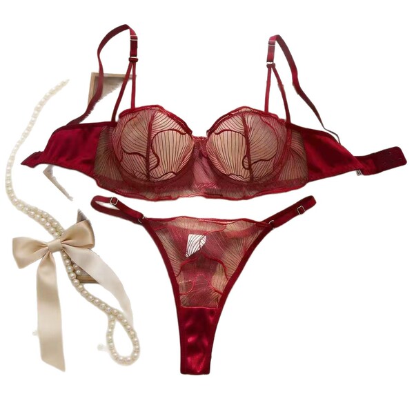 Wine red plus size lingerie set featuring sheer mesh bra and panty with lace cutouts, paired with a pearl necklace and bow.