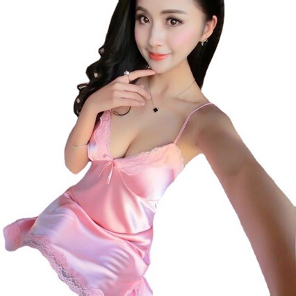 Woman modeling a pink silky deep v lingerie nightgown set, featuring delicate lace trim and sensual design for adults.