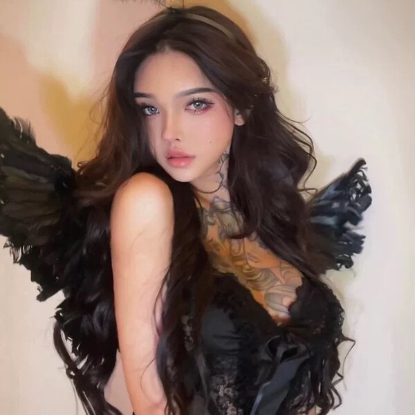 Woman in black lace sleep set with angel wings, romantic lingerie for couples.