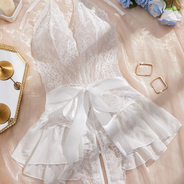 Womens full lace sheer bodysuit featuring delicate lace design, elegant halter neck, and ruffled skirt with bow tie detail. p...