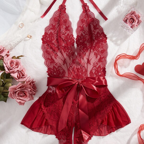Womens full lace sheer bodysuit featuring intricate lace design, deep v-neckline, and elegant red ribbon waistband, perfect f...