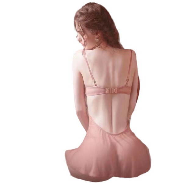 Woman wearing pink low-cut push-up lace chemise set with matching thong, showcasing back view of satin sleepwear.