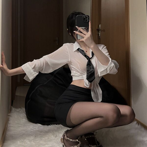 Woman in white blouse and black pencil skirt posing with phone, wearing matching sleepwear set for office or costume.