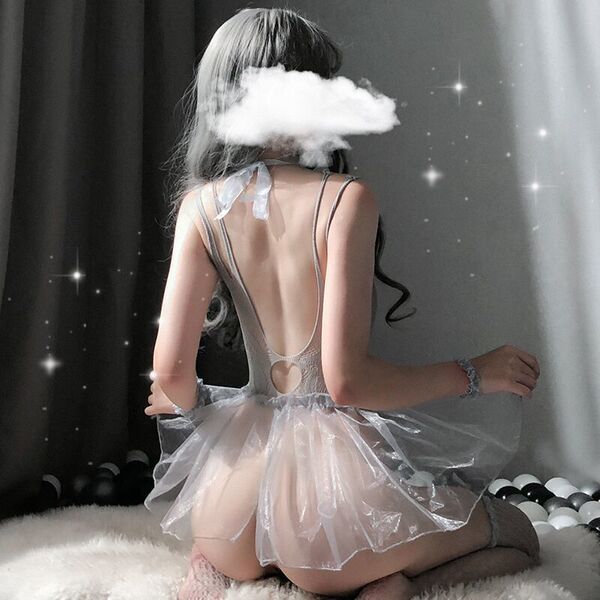 Woman wearing sheer lace bodysuit with puff sleeves and tulle skirt, romantic lingerie set for sleepwear.