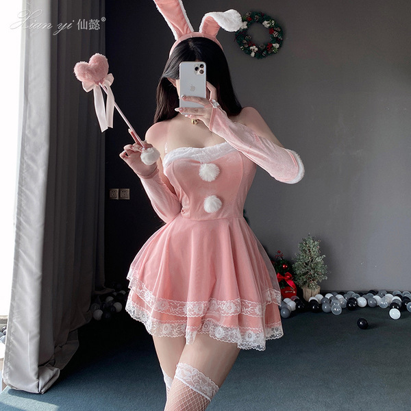A woman poses wearing a festive bunny-themed red velvet costume, complete with bunny ears, gloves, and stockings, perfect for...
