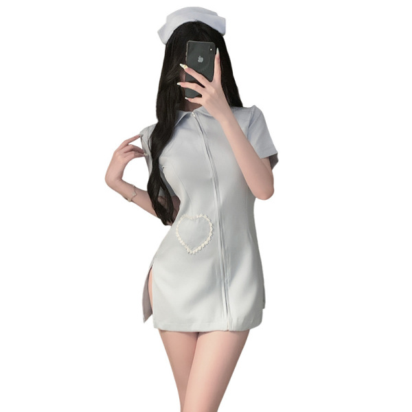 Woman wearing white xianyi sexy nurse costume with heart detail, open-crotch design for cosplay and role play.