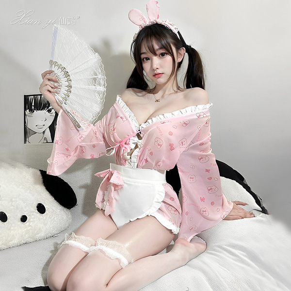 A woman poses wearing a cute pink bunny-themed japanese-inspired kimono-style lingerie set, complete with bunny ears and lace...