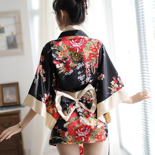 A woman wears a xiucisha kimono-style seductive sleep dress featuring vibrant floral patterns and a bow tie, perfect for inti...