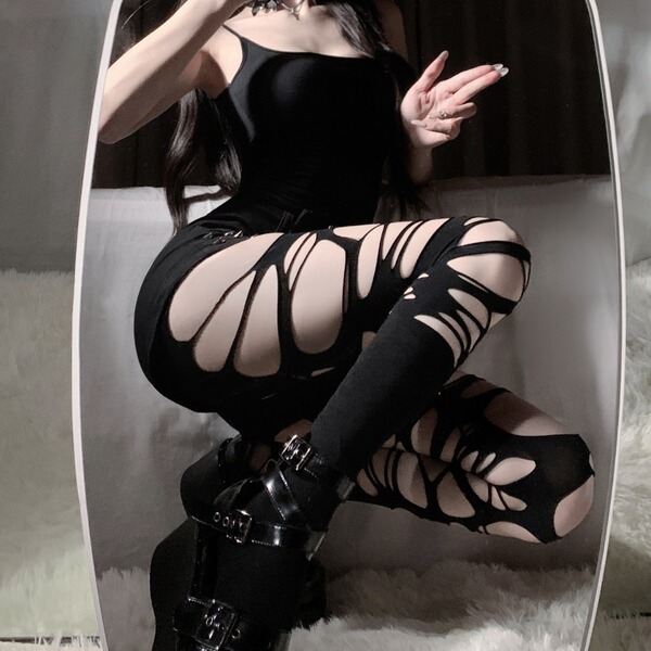 Edgy black y2k ripped thigh-high socks with lace-up leg warmers, perfect for bold fashion statements.