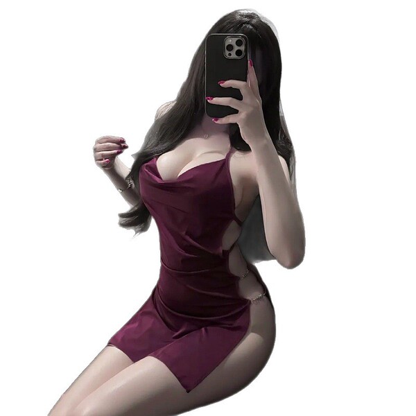 Woman in burgundy yaqin nu lingerie set with low-cut neckline and high slit, posing seductively while holding phone to face.