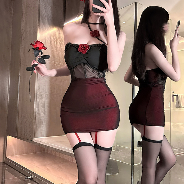 A woman poses in a mirror wearing a black and red new year pure & tempting lingerie skirt, featuring rose details and sheer f...
