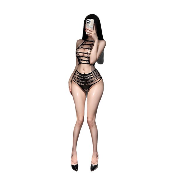 Woman wearing yese yese lace trim mesh bodysuit set with sheer floral cut-out bra and panty, posing in black heels.