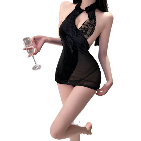 Woman in black lace yese yese qipao nightgown holding champagne glass.