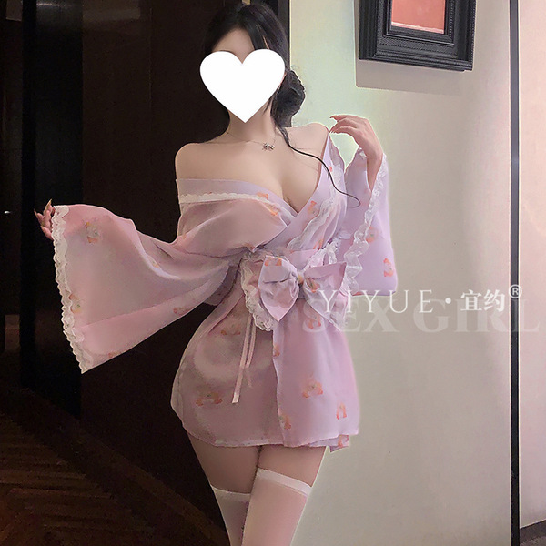 A woman wears a delicate pink yiyue original kawaii bunny kimono lingerie set, featuring floral patterns and lace details, pe...