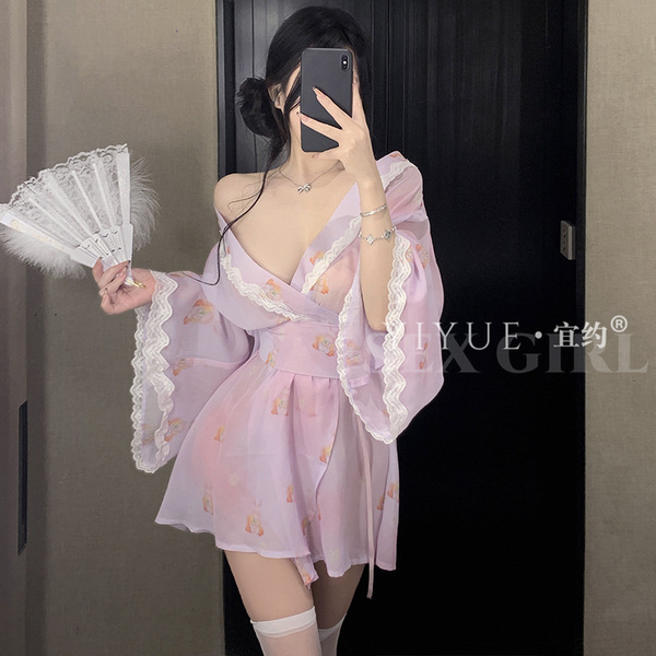 A woman poses in a pink yiyue original kawaii bunny kimono lingerie set, featuring delicate lace details and playful bunny mo...