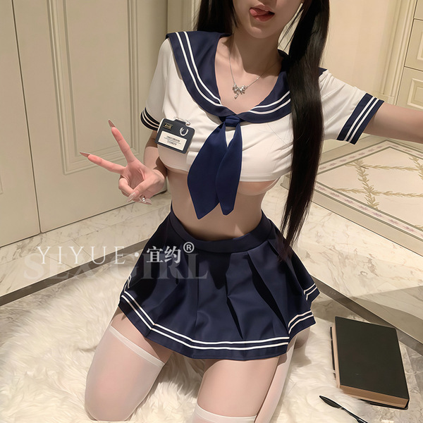 A woman poses wearing a yiyue sexy schoolgirl jk uniform set, featuring a sailor-style top with a tie and pleated skirt, perf...