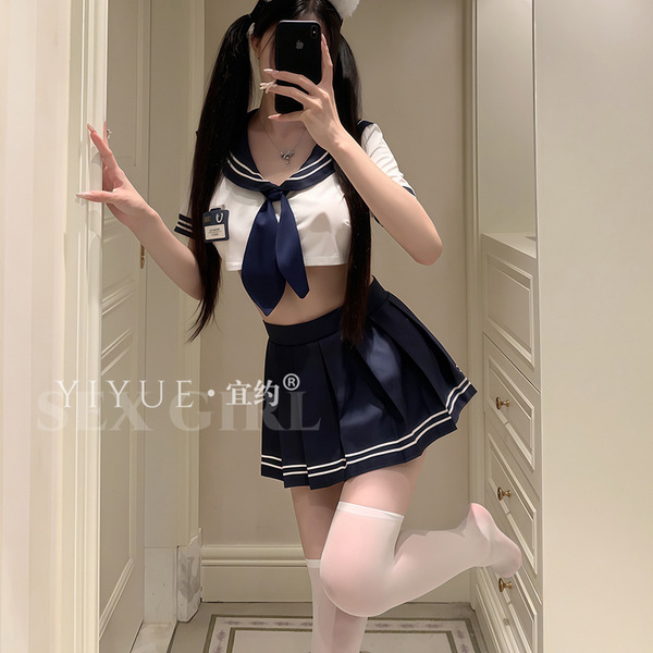 A person wearing a schoolgirl uniform set, featuring a sailor-style top with a blue bow tie and pleated skirt, paired with th...