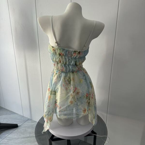 Back view of yuanshun floral lace dress on mannequin, featuring sheer mesh bodycon design with delicate spaghetti straps.