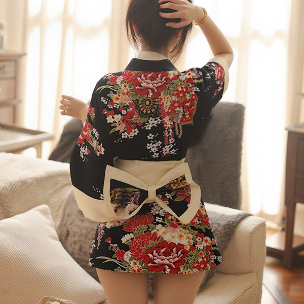 A woman wears a yufei japanese-style robe set featuring vibrant floral patterns, with a decorative bow at the waist, perfect ...