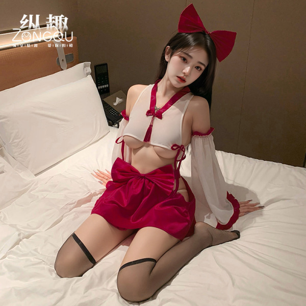 Woman modeling zhongqu sexy chinese-style lingerie set with sheer top, red bow skirt, and thigh-high stockings on bed.