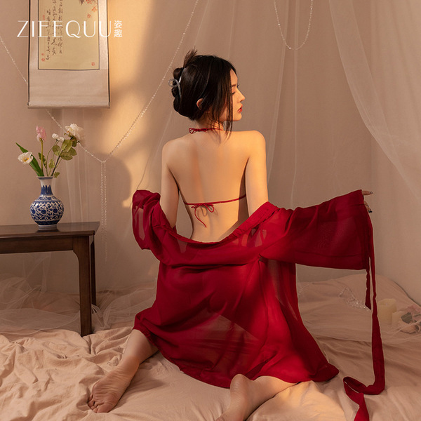 A woman sits on a bed wearing a red silk bodysuit with sheer veil, part of the ziqu ancient chinese lingerie set, perfect for...