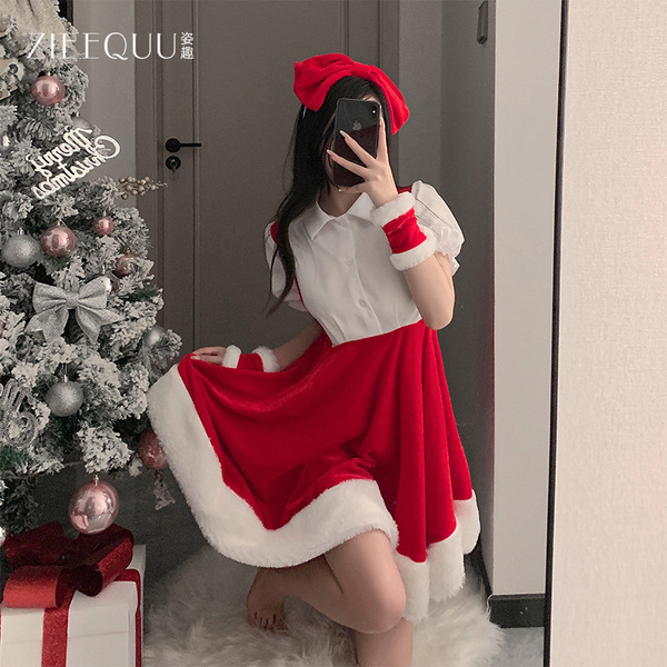 A woman poses with a christmas tree, wearing a festive red and white santa outfit from ziqu new years collection, perfect for...