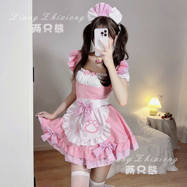 A woman wearing a pink maid dress with ruffles and bows, perfect for cosplay or anime-themed events.