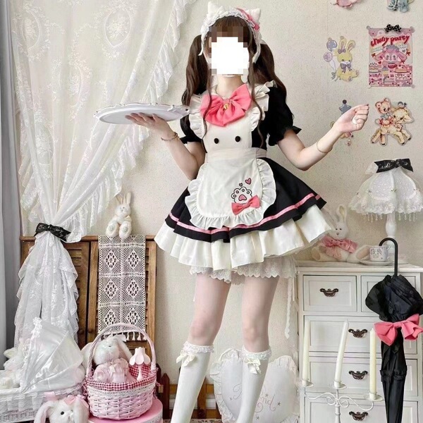 A woman models a maid costume cosplay dress, featuring a cute student lolita outfit with a black and white apron, pink bow, a...