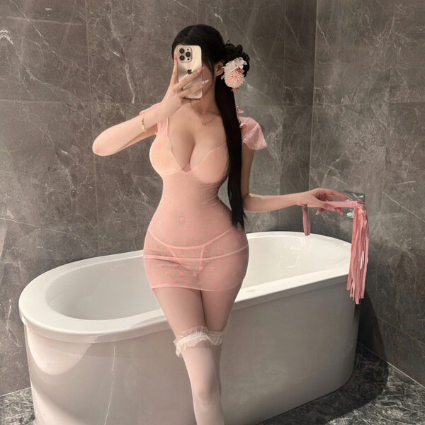Woman in pink sheer bodycon mini dress with lace trim, posing by bathtub. night si night se sexy lingerie set – seductive sle...
