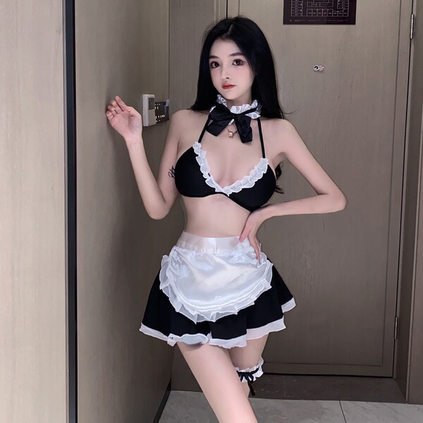Woman wearing black and white pure & playful maid costume set with lace trim, bow choker, apron, and thigh-highs — sexy cute ...