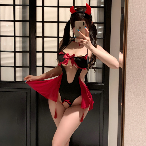 Woman in mirror wearing black and red pure & seductive lingerie set with devil horns, bow details, and flowing robe.