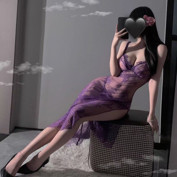 Woman wearing purple lace lingerie set with sheer strap nightdress, high slit, and uniform-inspired design.