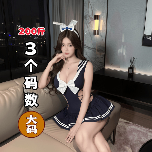 A woman wearing a navy blue sailor-style sleepwear set with white accents, featuring three-quarter coverage and a bow detail....