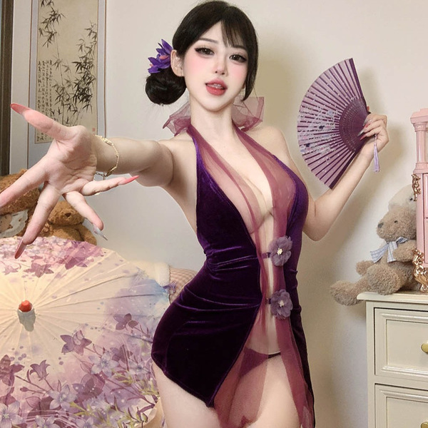 Woman wearing seductive purple cheongsam lingerie set with open back, holding fan, in cozy bedroom setting.