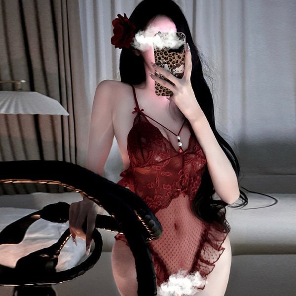 Woman wearing red sensual lace bodysuit with sheer mesh, open-crotch design, and provocative uniform style, holding phone.