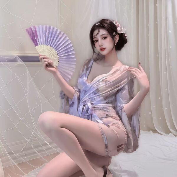 Woman in sheer butterfly-print kimono robe, braless design, holding purple fan—seductive sleepwear for women.