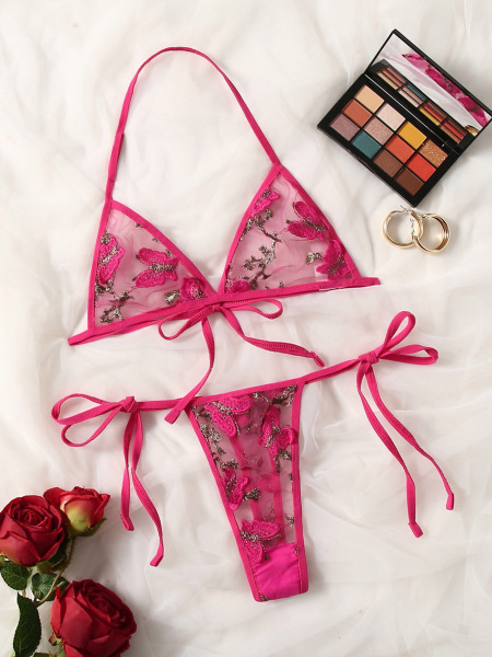 Pink lace bra and thong set with floral embroidery, elegant bridal or vacation lingerie for women.