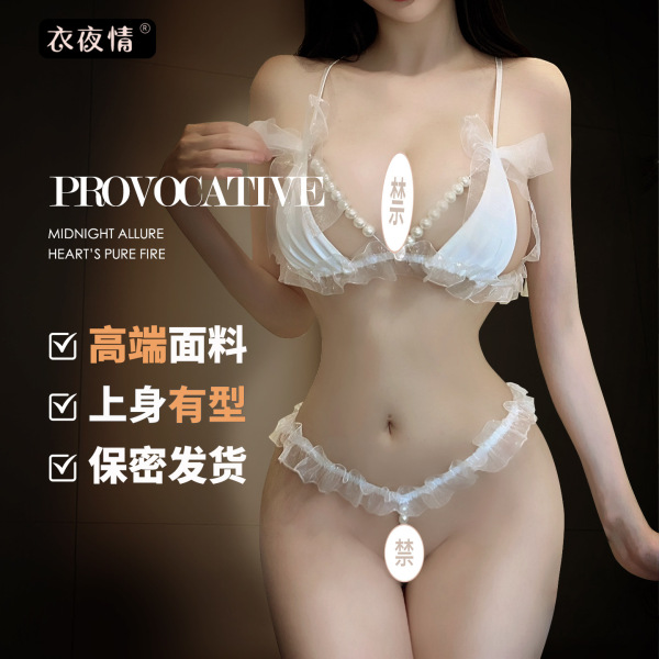 Woman modeling white pearl-embellished lace lingerie set with sheer bra and ruffled panties, romantic nightwear.