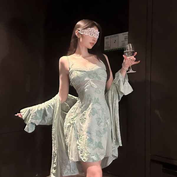 Woman wearing chaomu lace print lingerie set with sheer cami, matching briefs, and robe, holding wine glass.