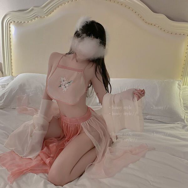 Woman in pink sheer chiffon chinese style doudou bralette and vintage lingerie set on bed, pure and tempting sleepwear.