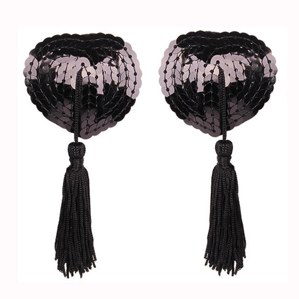 Heart-shaped silicone bra inserts with sequins and lace trim, featuring black tassels for a flirty look.