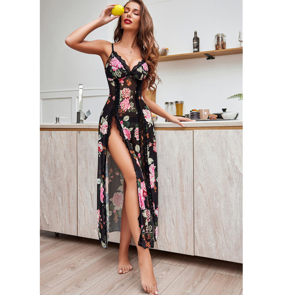 A woman poses in a kitchen wearing a black lace trim strap nightgown with a sexy sheer split front and floral print, inspired...