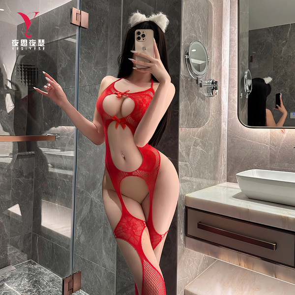 Woman in red nightsigh lace bodysuit taking a mirror selfie, showcasing sheer mesh halter design and intricate cutouts.