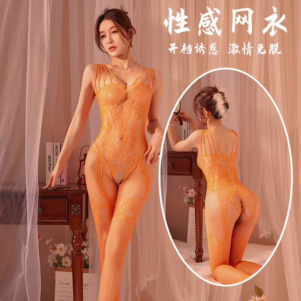 Woman modeling orange plus size sexy lace fishnet bodystocking with tear-away crotch, sheer mesh lingerie.