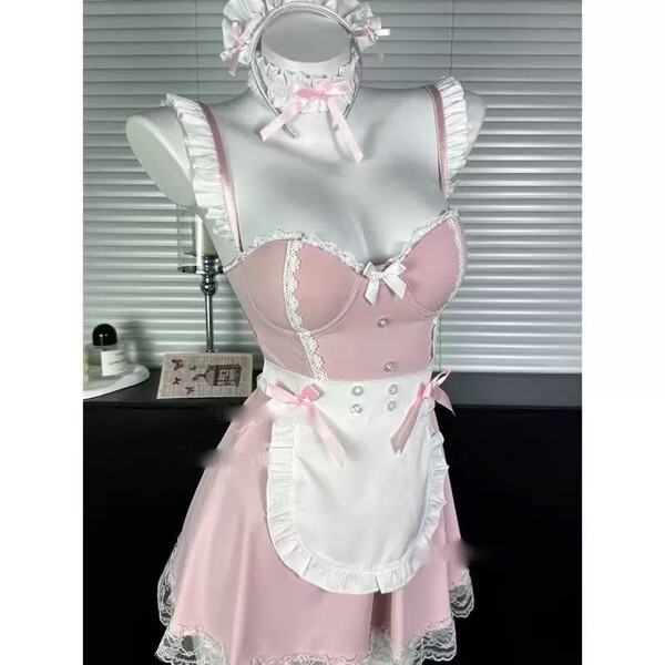 Pink and white lace lingerie set with apron, bow details, and maid-style headpiece on mannequin.