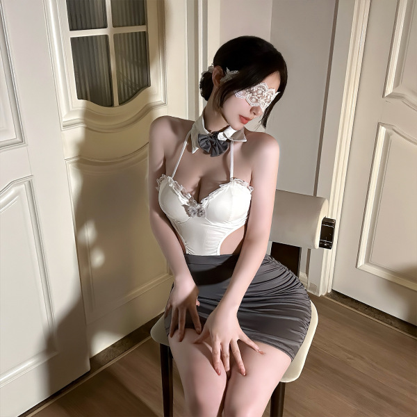 Woman wearing qingshe ol secretary lingerie set with lace bra, gray skirt, and eye mask, seated elegantly in a chic room.