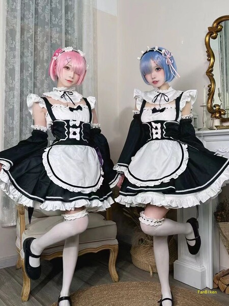 Two cosplayers dressed as ram and rem from re:zero, wearing maid outfits in lolita style. black and white dresses with ruffle...