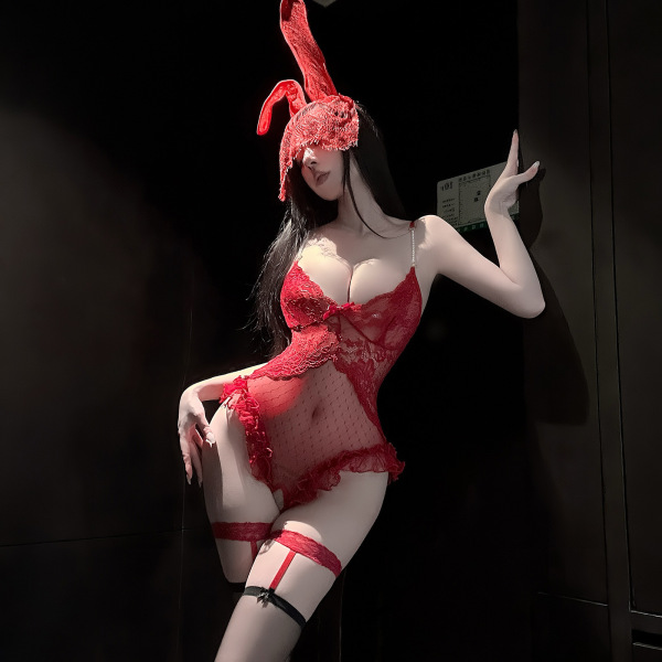 Woman wearing red lace bodysuit with bunny ears, sheer mesh panels, pearl chain straps, and matching garter belt.