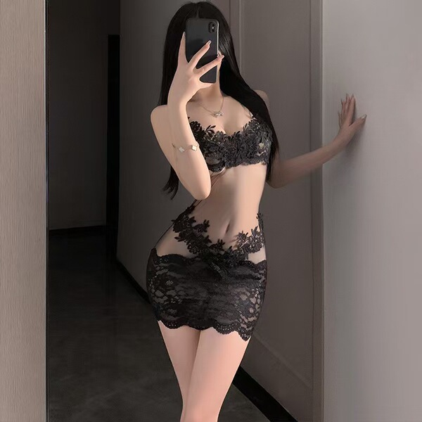 Woman wearing a black lace bodysuit with an open-crotch design, posing in a mirror for a playful date night look.